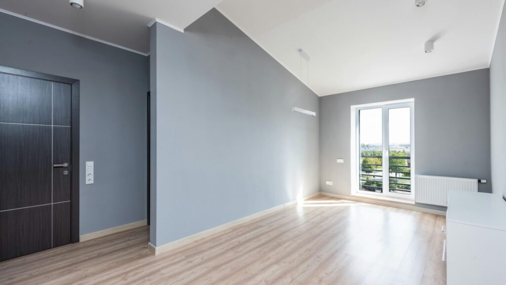 Bright, spacious minimalist room with wooden flooring and large window view. NickR - Seattle remodeling contractor
