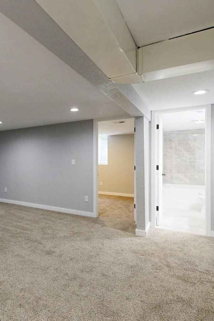 basement finishing contractors have done a project. grey walls, sandy color carpet. natural light